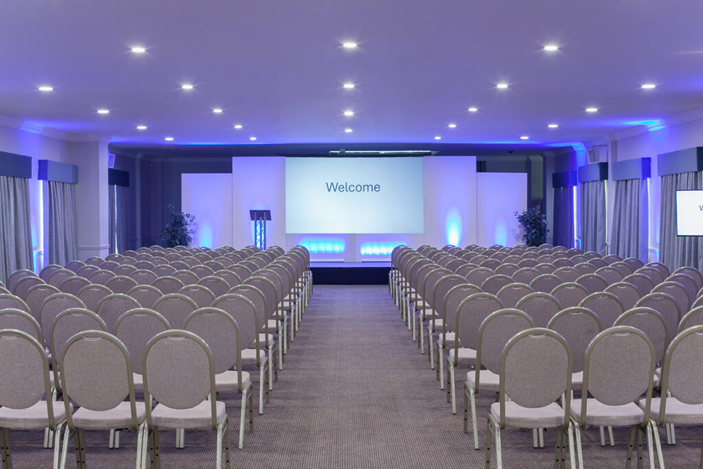 Aire-room-theatre-style-meeting-room-with-stage-set-gyec-web